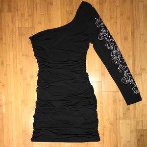 Black ruched one-sleeved mini dress.